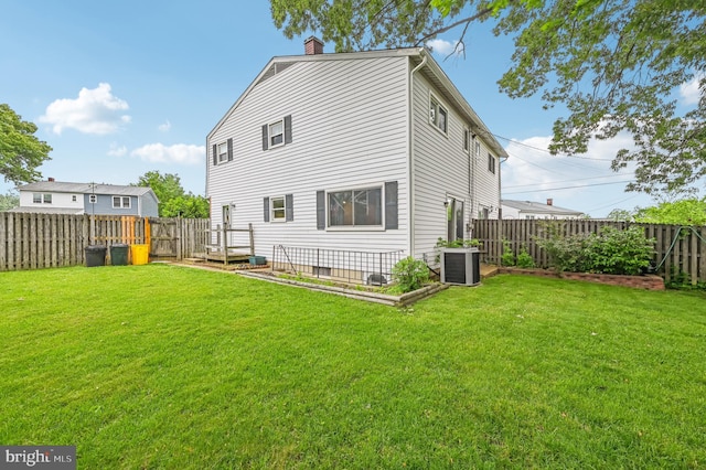 225 Dunlap Rd, Pasadena, MD 21122 - back of property with a chimney, cooling unit, and a garden