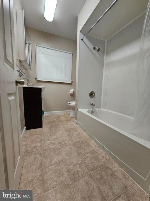 413 10th Ave, Altoona, PA 16602 - bathroom with toilet, shower / bathtub combination, tile patterned flooring, vanity, and baseboards