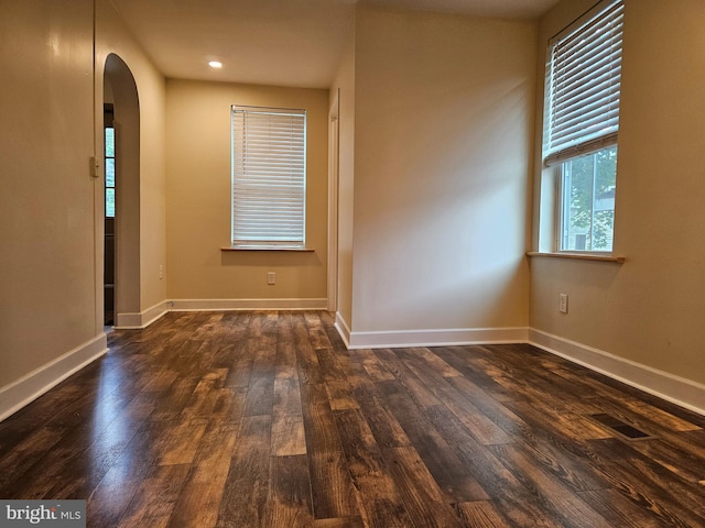 413 10th Ave, Altoona, PA 16602 - spare room featuring arched walkways, dark wood-style flooring, baseboards, and recessed lighting