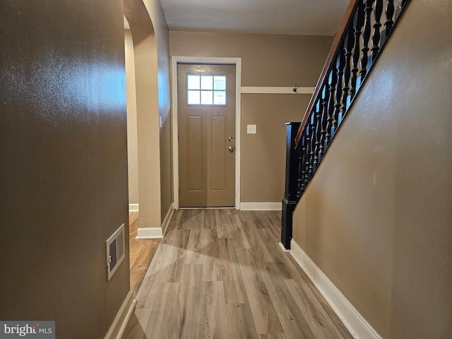 413 10th Ave, Altoona, PA 16602 - foyer entrance with wood finished floors, baseboards, stairway, and arched walkways