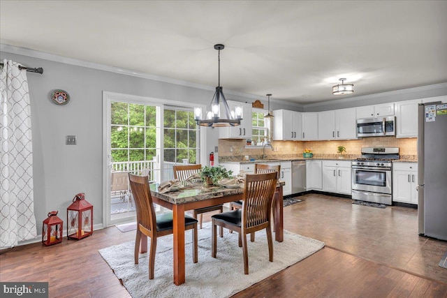 6 Hedwig Ct, Voorhees, NJ 08043 - dining area with crown molding, a chandelier, dark wood-style flooring, and baseboards
