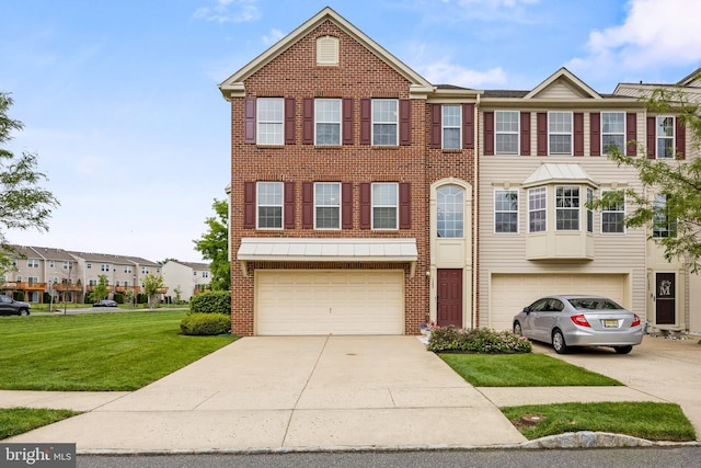 129 Helen Dr, Cinnaminson, NJ 08077 - townhome / multi-family property featuring concrete driveway, a garage, a front yard, and brick siding