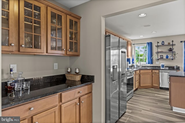 129 Helen Dr, Cinnaminson, NJ 08077 - kitchen featuring appliances with stainless steel finishes, light wood-type flooring, glass insert cabinets, recessed lighting, and dark stone countertops