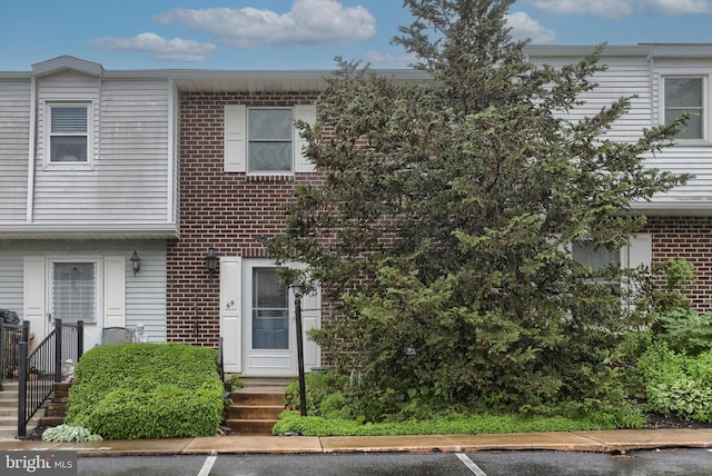 69 Drexel Pl, New Cumberland, PA 17070 - view of property featuring brick siding and uncovered parking