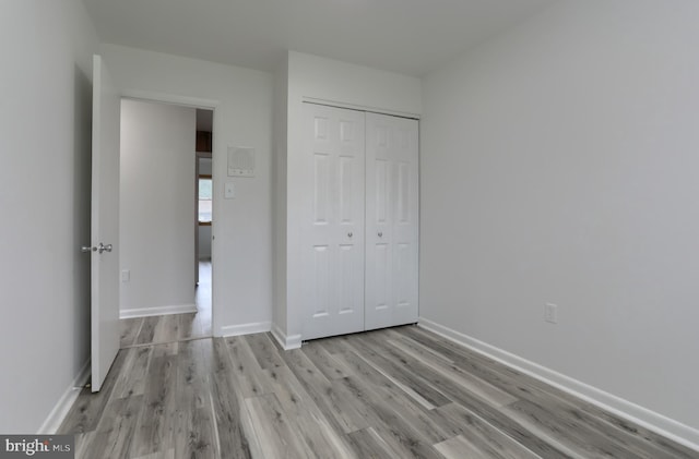 69 Drexel Pl, New Cumberland, PA 17070 - unfurnished bedroom with light wood-type flooring, a closet, and baseboards