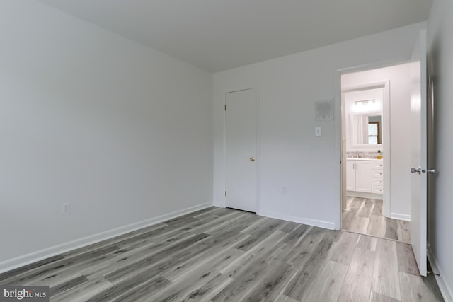 69 Drexel Pl, New Cumberland, PA 17070 - unfurnished bedroom featuring light wood-type flooring, baseboards, and a sink
