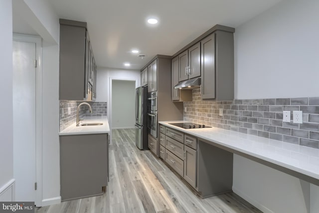 69 Drexel Pl, New Cumberland, PA 17070 - kitchen featuring a sink, gray cabinetry, under cabinet range hood, freestanding refrigerator, and recessed lighting