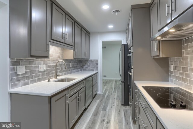 69 Drexel Pl, New Cumberland, PA 17070 - kitchen with a sink, black electric cooktop, under cabinet range hood, gray cabinetry, and recessed lighting