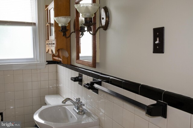 107 Bishops Ln, Baltimore, MD 21228 - bathroom featuring a sink, toilet, and a wainscoted wall