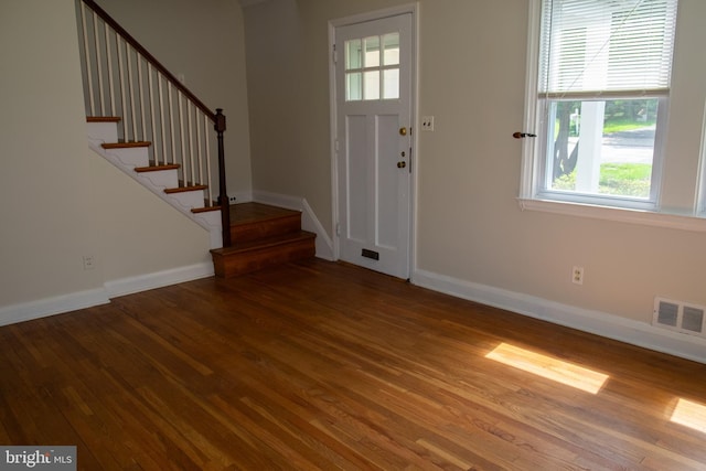 107 Bishops Ln, Baltimore, MD 21228 - foyer entrance featuring wood finished floors, plenty of natural light, stairway, and baseboards