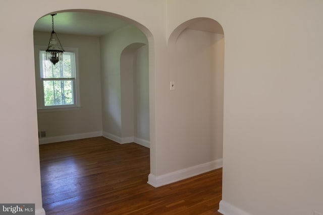 107 Bishops Ln, Baltimore, MD 21228 - unfurnished room featuring wood finished floors, baseboards, and arched walkways