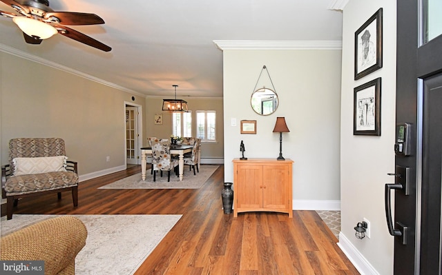 985 Jeffrey Dr, Southampton, PA 18966 - entrance foyer with ornamental molding, wood finished floors, baseboards, a baseboard radiator, and ceiling fan