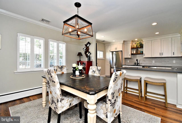 985 Jeffrey Dr, Southampton, PA 18966 - dining room featuring a chandelier, recessed lighting, dark wood-type flooring, crown molding, and a baseboard heating unit