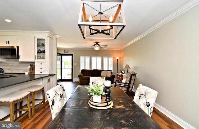 985 Jeffrey Dr, Southampton, PA 18966 - dining area with dark wood-style floors, baseboards, ornamental molding, a chandelier, and ceiling fan