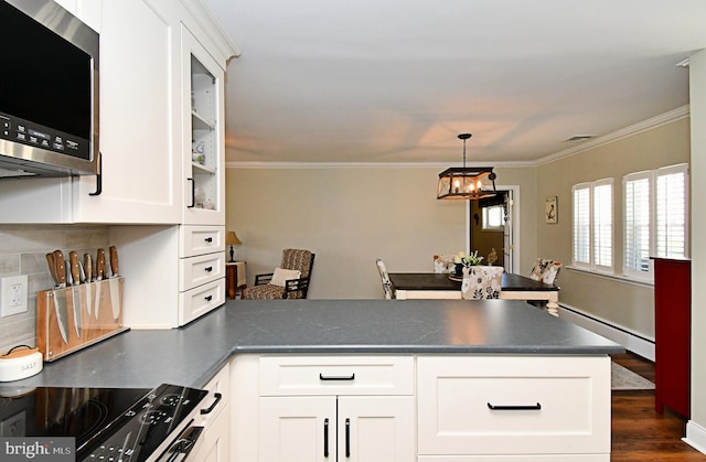 985 Jeffrey Dr, Southampton, PA 18966 - kitchen with a baseboard radiator, a peninsula, stainless steel microwave, white cabinetry, and dark countertops