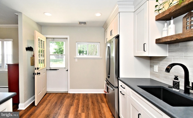 985 Jeffrey Dr, Southampton, PA 18966 - kitchen with a sink, freestanding refrigerator, dark countertops, dark wood finished floors, and white cabinetry