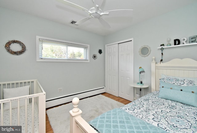 985 Jeffrey Dr, Southampton, PA 18966 - bedroom featuring a baseboard radiator, wood finished floors, a closet, and a ceiling fan
