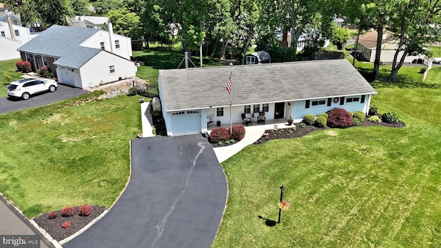 985 Jeffrey Dr, Southampton, PA 18966 - view of front facade with asphalt driveway, a garage, and a front yard