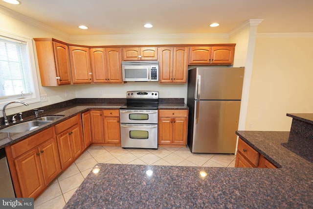 224 Canal Park Dr Unit 104, Salisbury, MD 21804 - kitchen featuring appliances with stainless steel finishes, a sink, light tile patterned flooring, crown molding, and dark stone counters