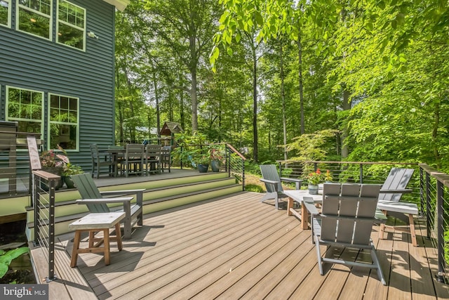 166 Nutwell Rd, Deale, MD 20751 - wooden deck with outdoor dining area and view of scattered trees