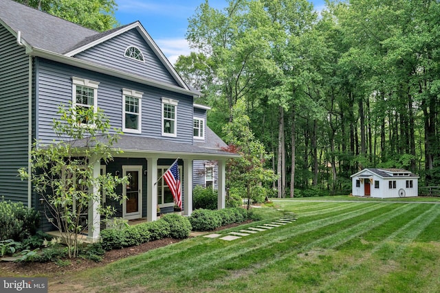 166 Nutwell Rd, Deale, MD 20751 - view of front facade featuring a front yard, an outdoor structure, and a shingled roof
