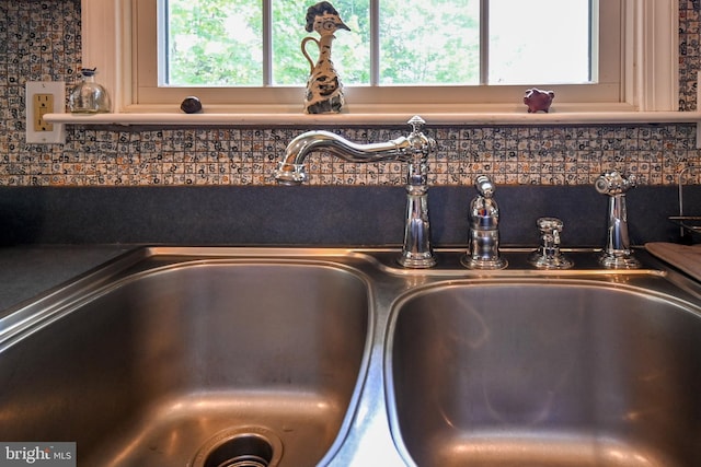 170 Vaughndom Way, Martinsburg, WV 25404 - detailed view of a sink, tasteful backsplash, dark countertops, and cream cabinetry