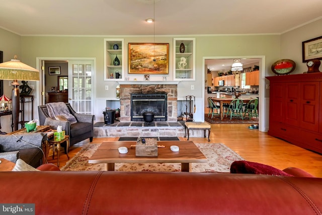 170 Vaughndom Way, Martinsburg, WV 25404 - living room with wood finished floors, ornamental molding, a stone fireplace, and built in features