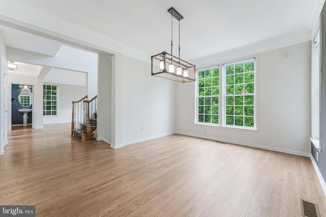 21934 Windover Dr, Broadlands, VA 20148 - unfurnished dining area featuring light wood-style flooring, stairs, ornamental molding, baseboards, and a chandelier