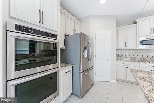 21934 Windover Dr, Broadlands, VA 20148 - kitchen with stainless steel appliances, decorative backsplash, white cabinets, and light tile patterned floors