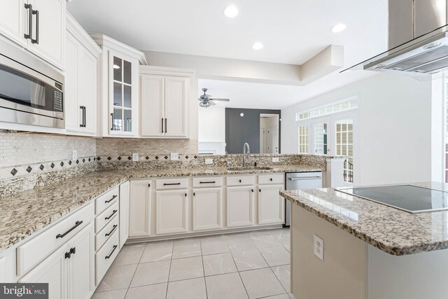 21934 Windover Dr, Broadlands, VA 20148 - kitchen with stainless steel appliances, a sink, a peninsula, light tile patterned floors, and decorative backsplash