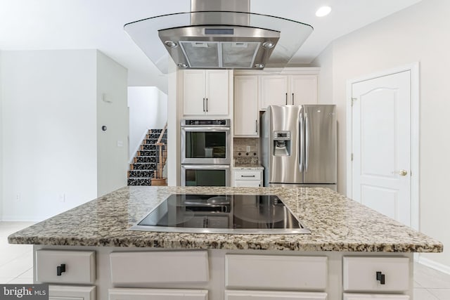 21934 Windover Dr, Broadlands, VA 20148 - kitchen with stainless steel appliances, light stone counters, light tile patterned floors, baseboards, and white cabinets