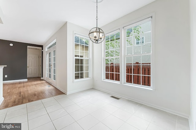 21934 Windover Dr, Broadlands, VA 20148 - unfurnished dining area with a chandelier, baseboards, and tile patterned flooring