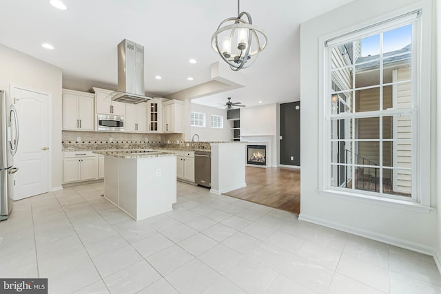 21934 Windover Dr, Broadlands, VA 20148 - kitchen with stainless steel appliances, open floor plan, island exhaust hood, healthy amount of natural light, and recessed lighting
