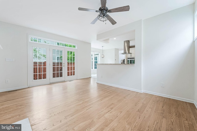 21934 Windover Dr, Broadlands, VA 20148 - unfurnished living room featuring light wood finished floors, plenty of natural light, baseboards, and a ceiling fan
