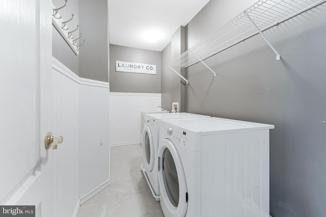 21934 Windover Dr, Broadlands, VA 20148 - washroom featuring washer and clothes dryer and a wainscoted wall