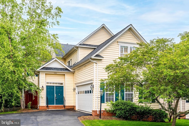21934 Windover Dr, Broadlands, VA 20148 - view of front of property featuring driveway, roof with shingles, and an attached garage