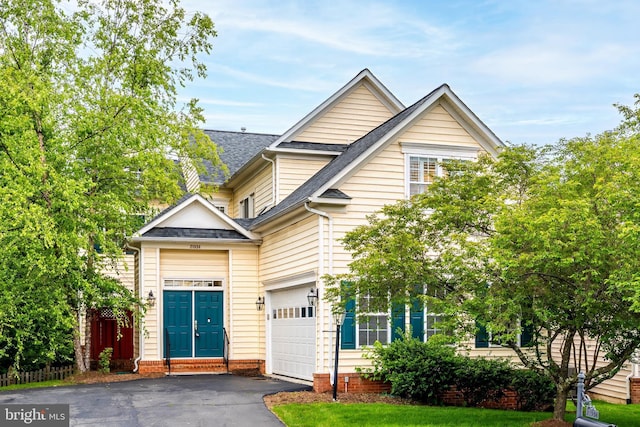 21934 Windover Dr, Broadlands, VA 20148 - view of front of home featuring asphalt driveway, roof with shingles, and a garage