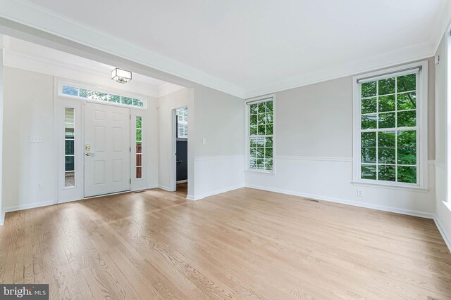 21934 Windover Dr, Broadlands, VA 20148 - foyer entrance with healthy amount of natural light, light wood-style flooring, crown molding, and baseboards