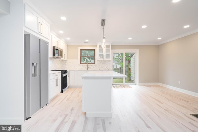 1420 Alexander Way, Bensalem, PA 19020 - kitchen with stainless steel appliances, backsplash, light countertops, white cabinetry, and ornamental molding
