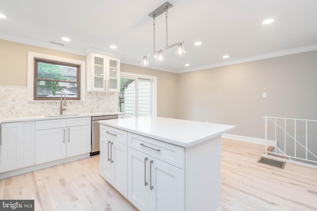 1420 Alexander Way, Bensalem, PA 19020 - kitchen featuring a sink, ornamental molding, dishwasher, light wood-type flooring, and decorative backsplash