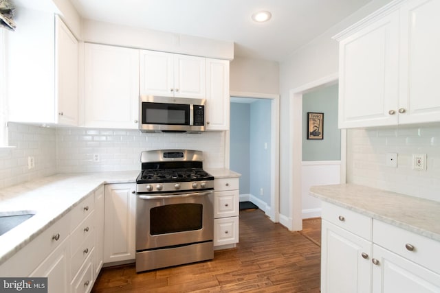 6306 Blackburn Ct, Baltimore, MD 21212 - kitchen featuring appliances with stainless steel finishes, decorative backsplash, white cabinetry, light wood-type flooring, and recessed lighting