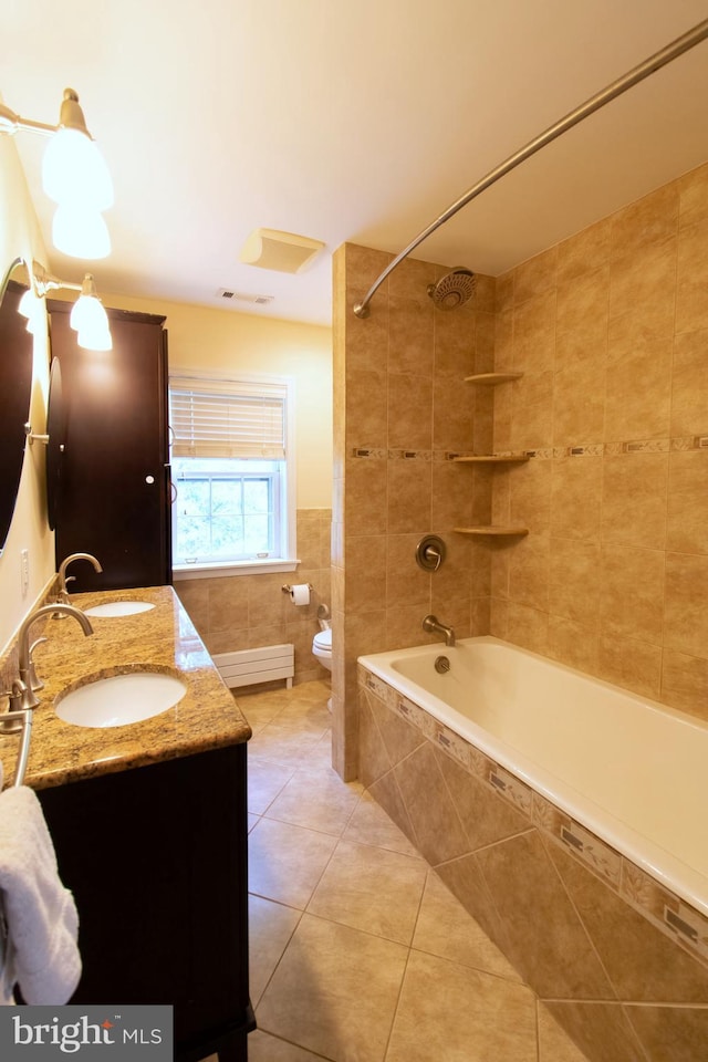 6306 Blackburn Ct, Baltimore, MD 21212 - bathroom with tile patterned floors, double vanity, tile walls, toilet, and tiled shower / bath combo