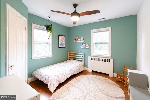 6306 Blackburn Ct, Baltimore, MD 21212 - bedroom featuring radiator, wood finished floors, baseboards, and ceiling fan