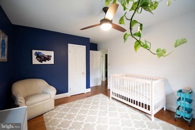 6306 Blackburn Ct, Baltimore, MD 21212 - bedroom with wood finished floors, baseboards, a nursery area, and a ceiling fan