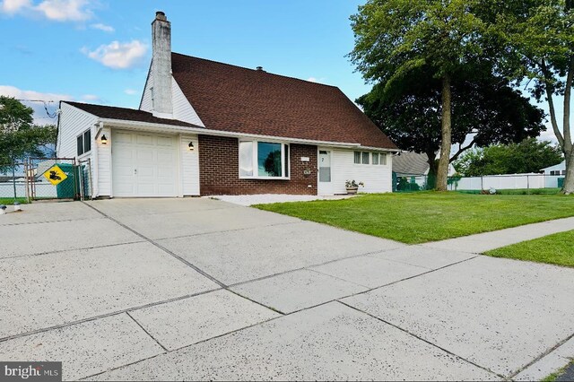 7 Hay Rd, Levittown, PA 19056 - view of front of house featuring a garage, driveway, a chimney, and brick siding