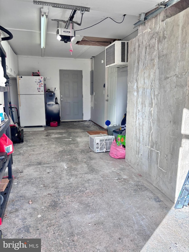 7 Hay Rd, Levittown, PA 19056 - garage with freestanding refrigerator, electric panel, and a garage door opener
