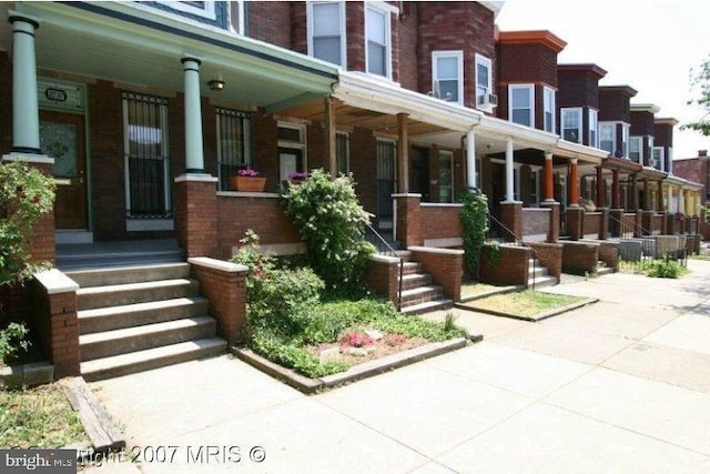 2737 Guilford Ave, Baltimore, MD 21218 - property entrance featuring covered porch and brick siding