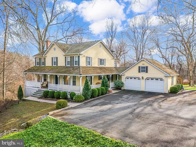 9020 Old Dominion Dr, Mclean, VA 22102 - view of front of property featuring covered porch, driveway, a chimney, and an attached garage