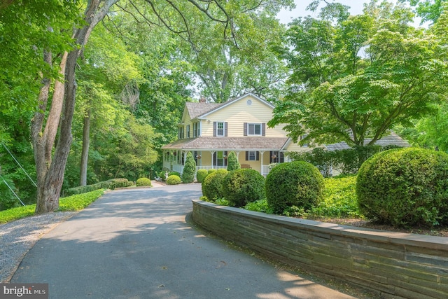9020 Old Dominion Dr, Mclean, VA 22102 - view of front of property featuring asphalt driveway, a chimney, and a porch
