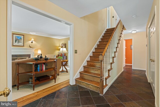 9020 Old Dominion Dr, Mclean, VA 22102 - stairs with a fireplace, stone tile flooring, baseboards, and crown molding